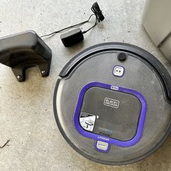 Black and decker + pet care automatic vacuum with charging dock.
