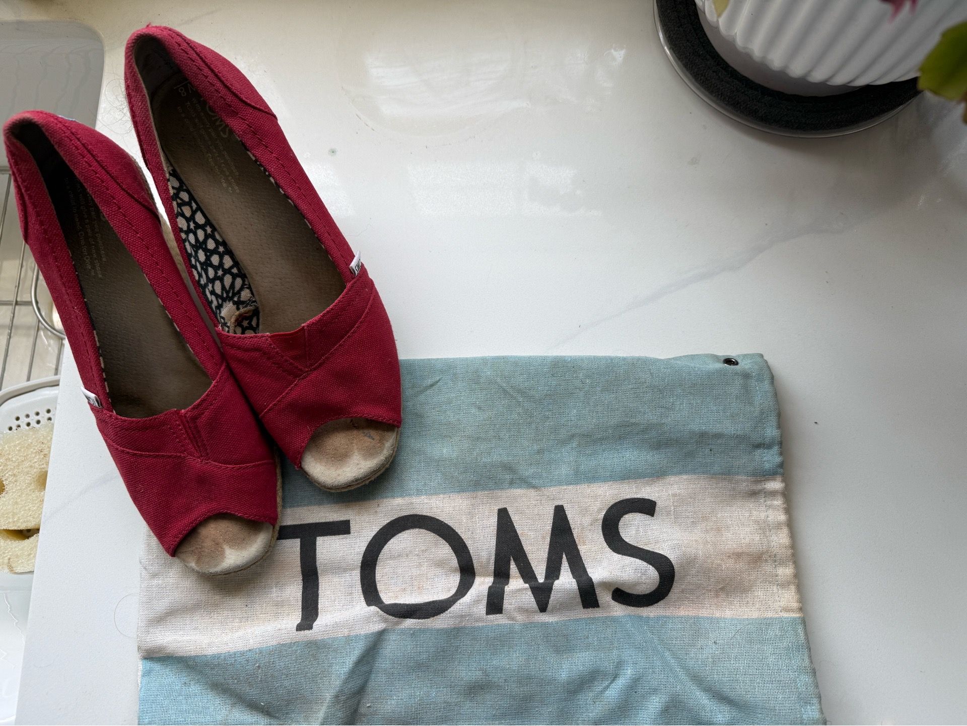 Tom’s red canvas heels