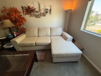 Beige sectional with reversible chaise and coffee table