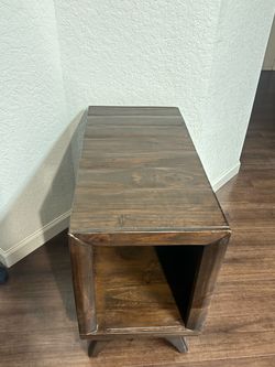 Dark wood side table with open shelf