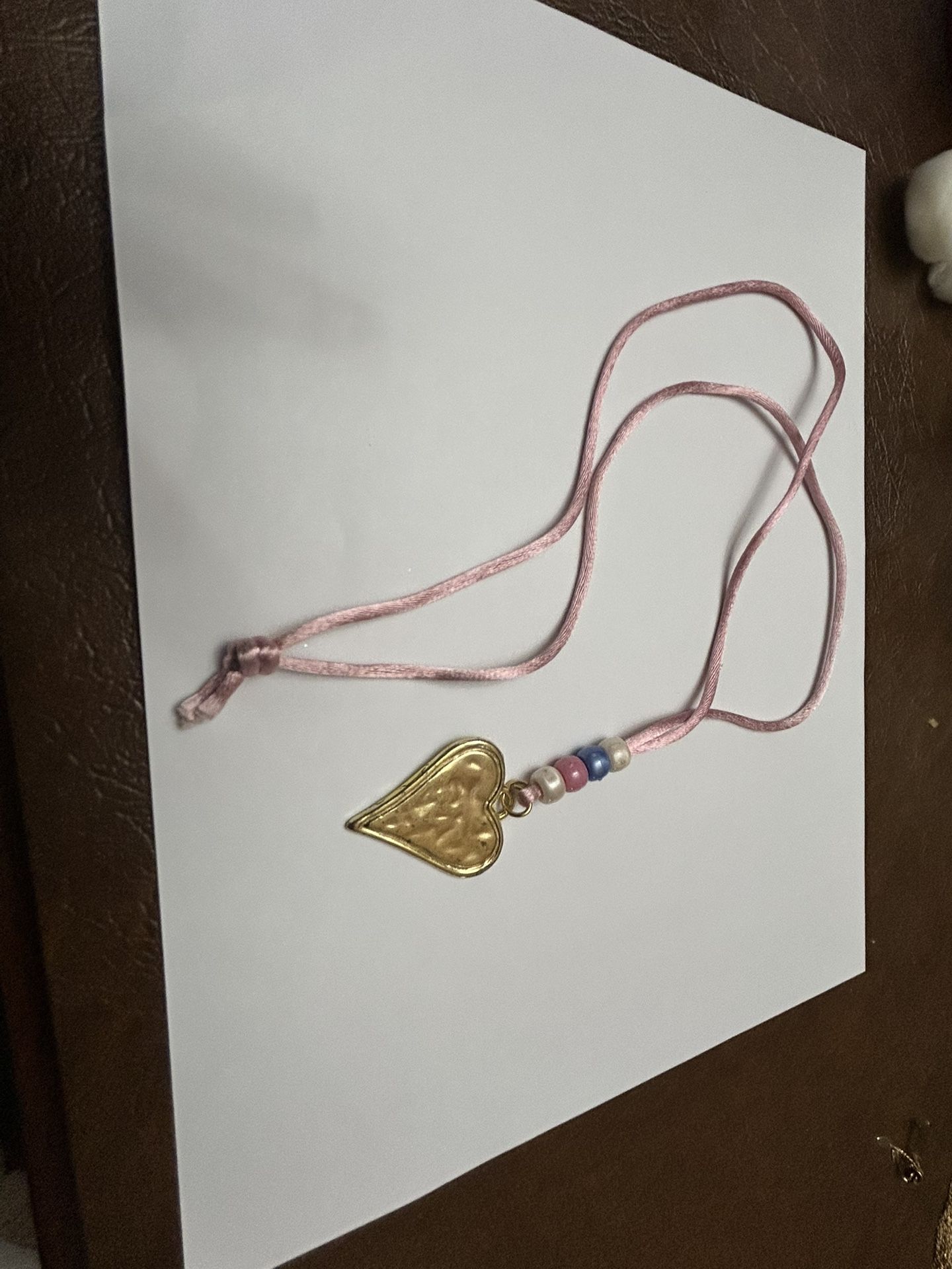 Heart, pendant, and pink cord with beads