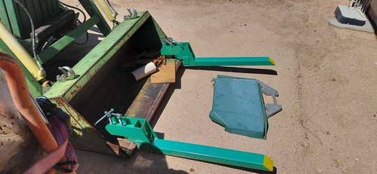 Skip loader fork lift arms