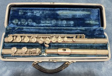 Silver flute in a blue velvet-lined case.
