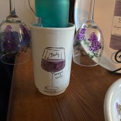 Wine bottle holder with cheese plate and bowl.
