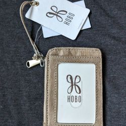 New Hobo Kai Leather Card holder in Stunning Golden Taupe. Zippered. Key Chain Attachment. 4x3"

Bold print lines the interior of a zippered leather