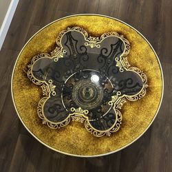 Vintage Hollywood Regency ornate glass-top coffee table with a metal and brass/gilt base 