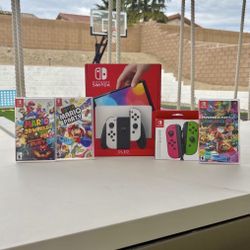 Nintendo switch Oled with extra controller and 3 Mario games floor model 