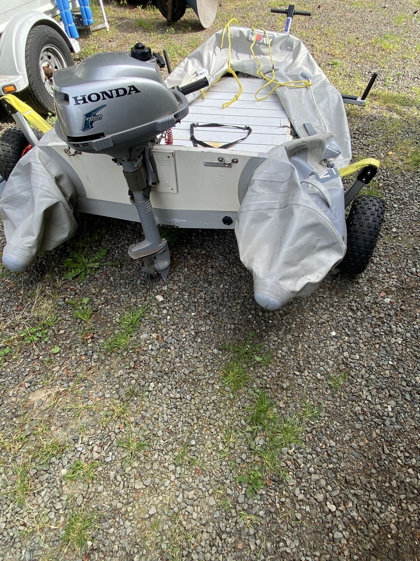 Blowup boat with hard bottom, electric motor or gas motor and trailer