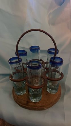 Vintage Mexican Hand Blown, cobalt blue rim deep, thick, heavy base shot glasses in a wood and metal stand.
