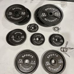 300 Pounds Of Olympic Weights in Great Condition, Olympic Barbell and Olympic Curl Barbell.