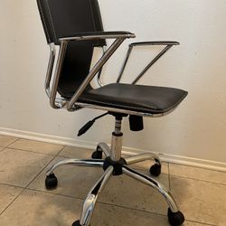 Desk Chair In Leather And Chrome. Adjustable With Wheels For Easy Moving Around