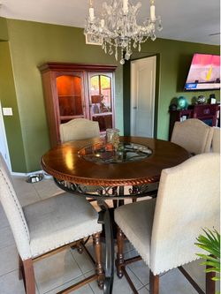 Bar top table, stools and lighted cabinet