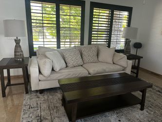 Off white sofa,  hardwood coffee table, end table, and lamps