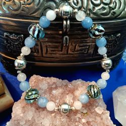 Blue and Powder pink semi precious Stone Bracelet Frame a hand blown glass bead of black-and-blue. Size large