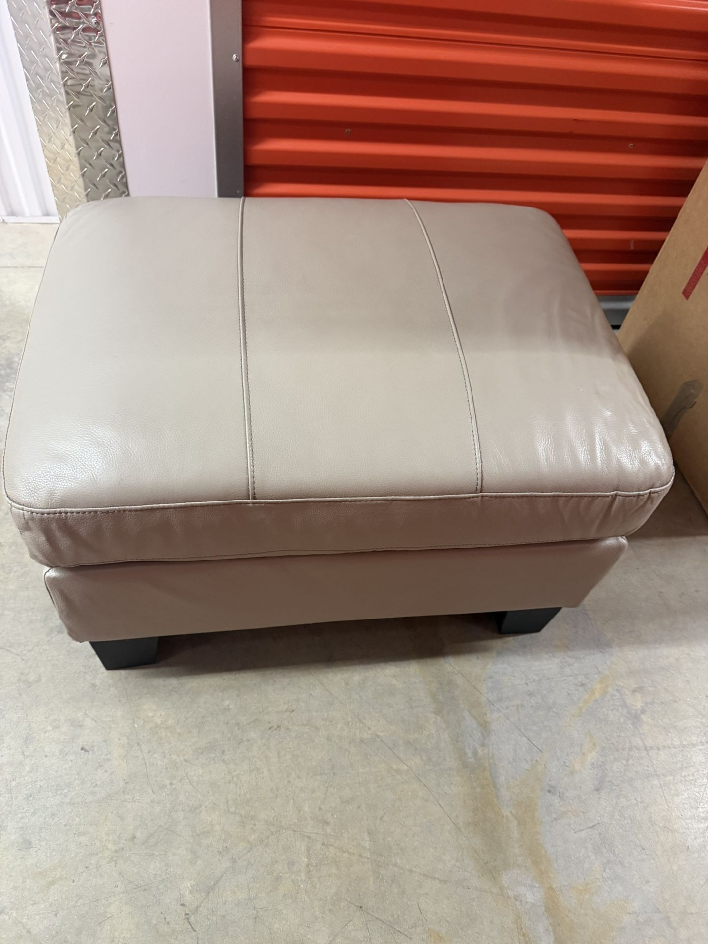 Three Person Beige Leather Couch And Ottoman