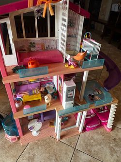 Barbie house and some furniture and toys and 2 Barbie Cars