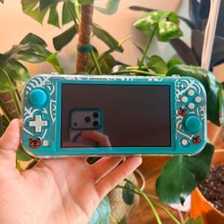 Nintendo switch lite with a case and a bag