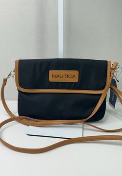 Nautica RFID blocking mini crossbody bag features a contrasting tan trim.