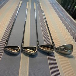 Nike Ignite golf irons, specifically the 4, 6, 9, and an "L" wedge or sand wedge iron.