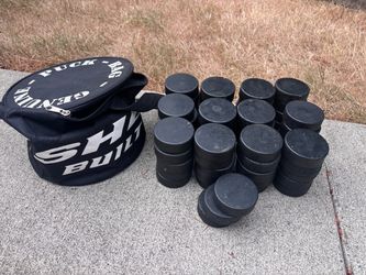 63 hockey pucks and a bag for them