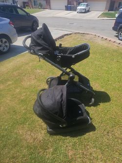 black Evenflo Pivot Xpand modular stroller with an attached infant car seat