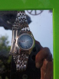 This vintage Seiko 2(contact info removed) automatic watch features a blue dial and a stainless steel band.