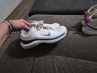 Nike Max Air women's golf shoes in white, blue, and gray.