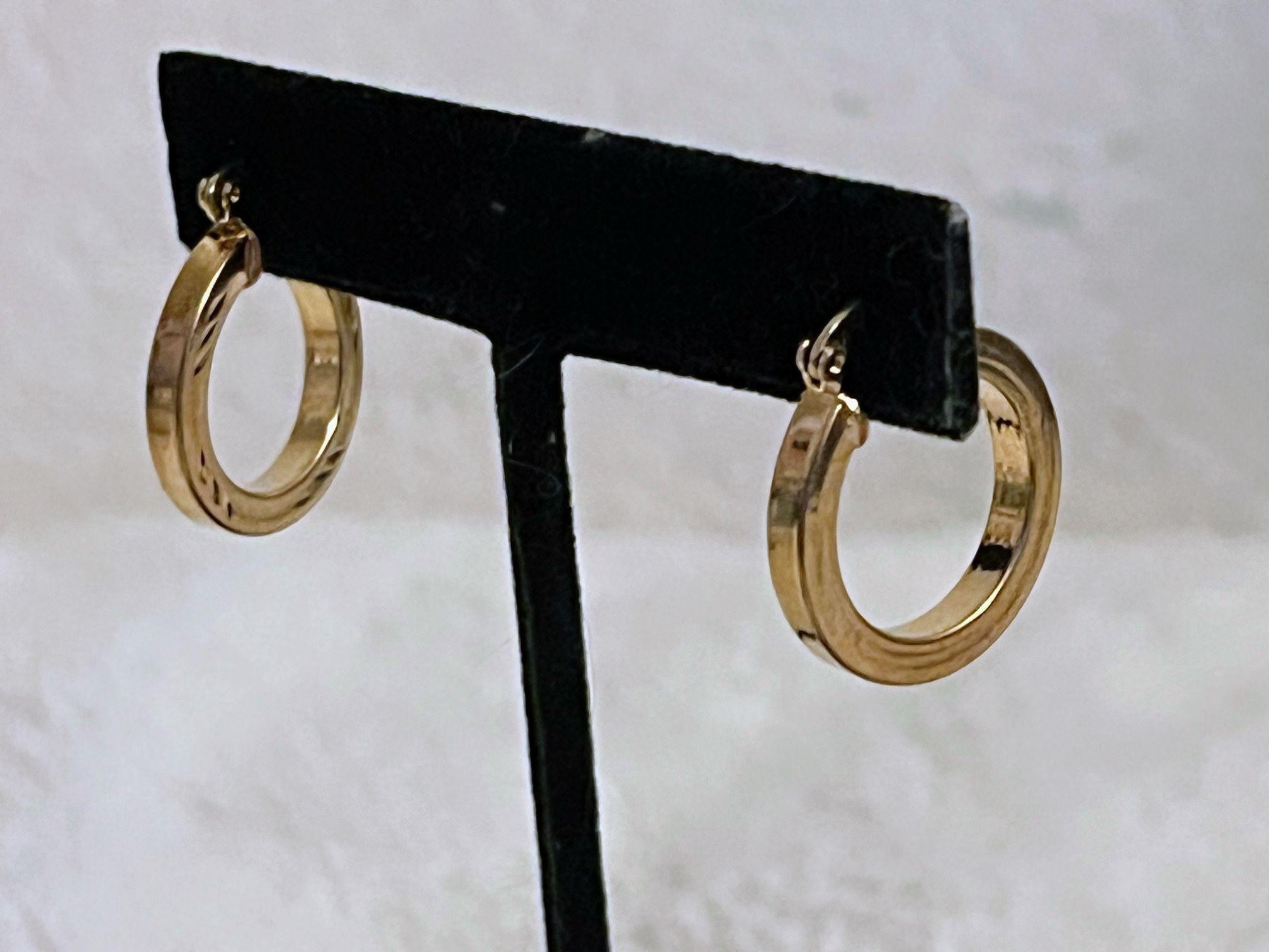 Gold plated hoop earrings with engraved design has the GHEL 