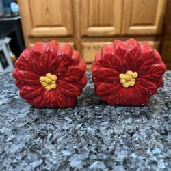 Ceramic Poinsettia Flower pair of Salt and Pepper Shakers. With Red Petals Yellow Center. Size approximately 2 3/4 inches tall. Brand new never used