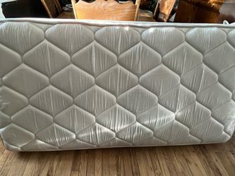 Twin bed frame, mattress, and box spring.