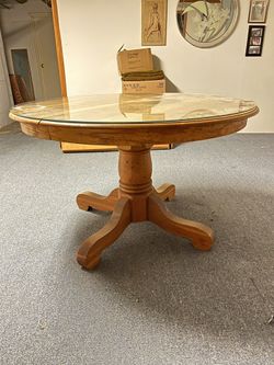 Solid oak pedestal table 48” with removable brushed glass protective top and two Leaves For Another 20 1/2”.  solid, and in great used condition