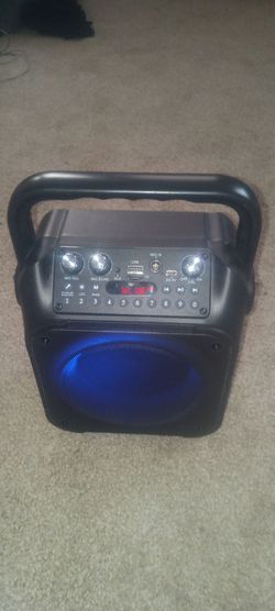 K9-M Portable Bluetooth Karaoke Machine featuring a black housing, a top-mounted carrying handle, and a front LED light ring.