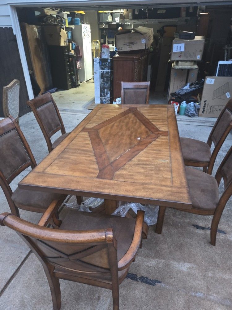 Nice Dining Table Set With Six Chairs. Bought from Ashley Furniture for 2 grand . It comes with four Matching Chairs (suede color) with two captain ch