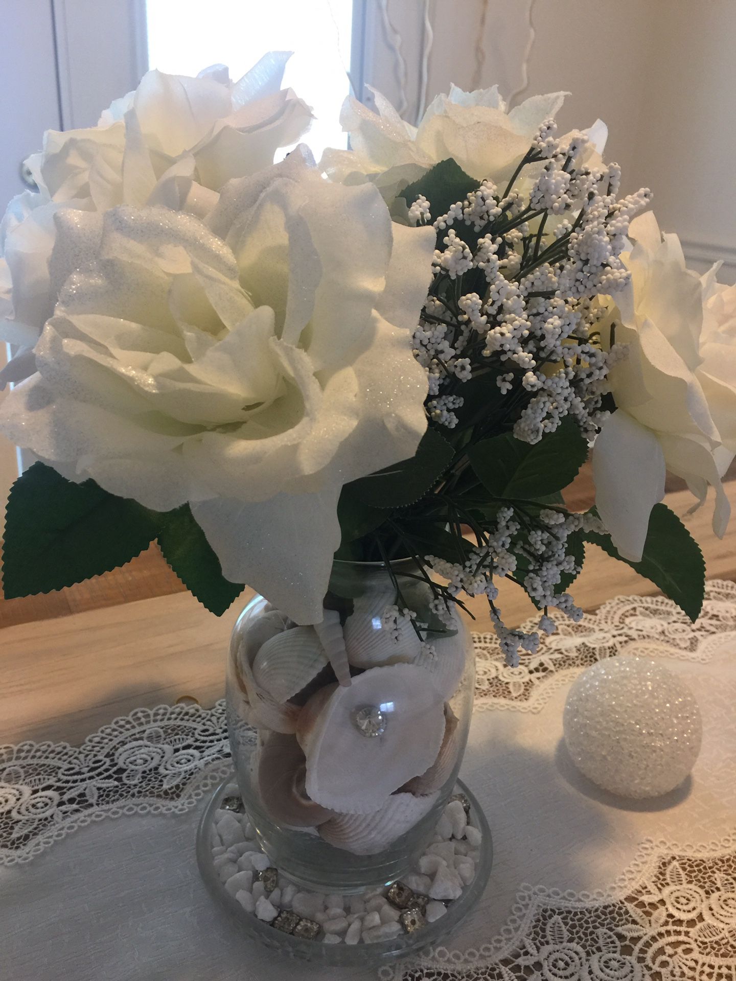 Sea shells vase with flowers