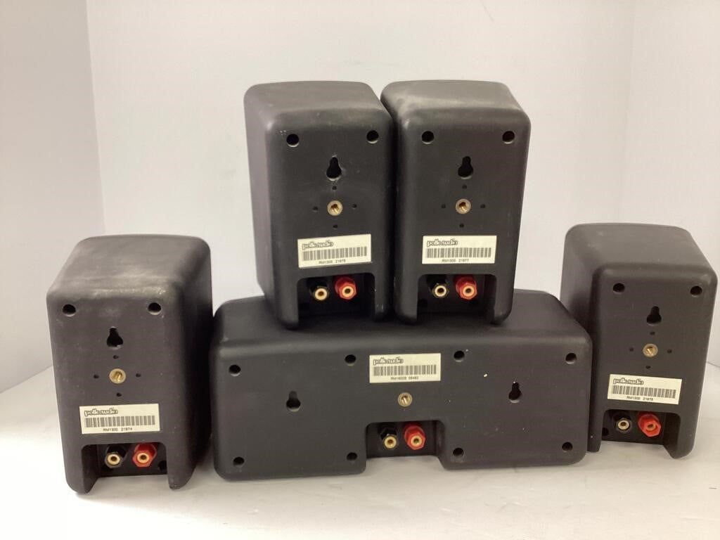 A set of Polk Audio RM6750 satellite speakers, designed for home theater systems. These compact speakers are known for their clear sound quality and a