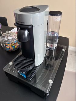 Nespresso coffee machine and the base for the cups