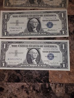 Us bills.  One $2 and four $1 silver certificates Red and blue ink.