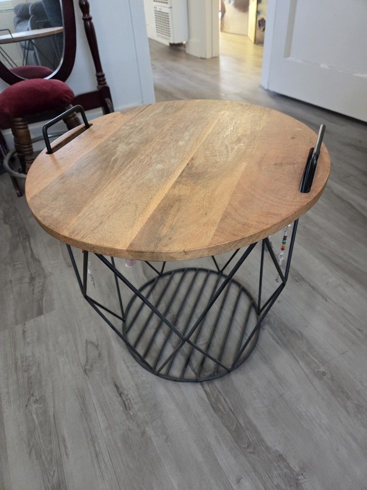 Small table, wood top, metal basket bottom $20