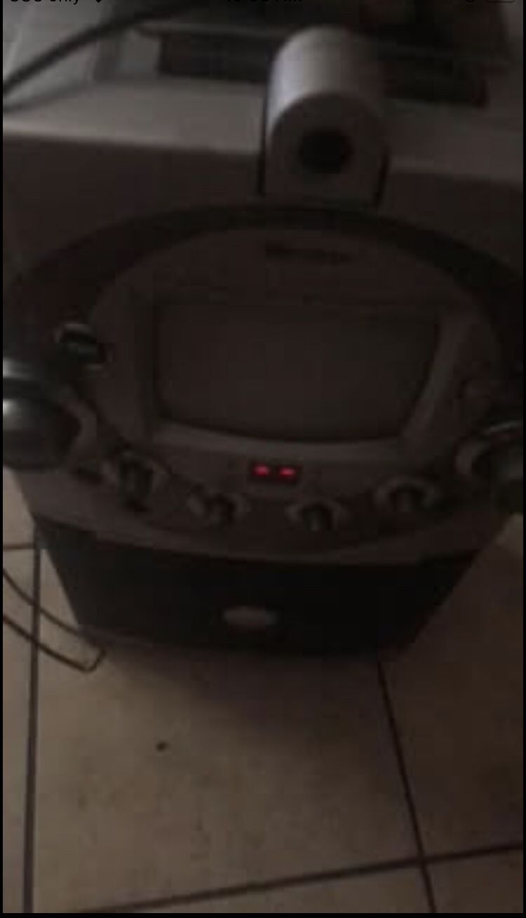 old karaoke machine with golden corded mic.