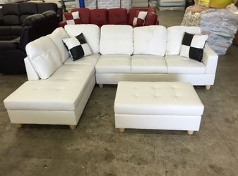 New in box white faux leather sectional with storage ottoman