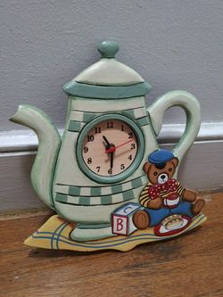 Wall Clock Shaped Like A Teapot, With A Teddy Bear Holding A Teacup Next To Lettered Blocks New