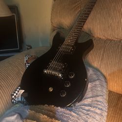 black electric guitar and amp