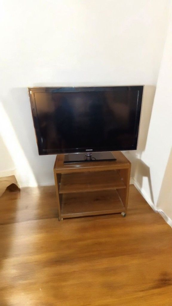 Samsung TV + stand on wheels. ​44". Includes manual and remote. 