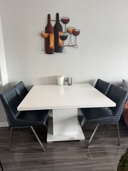 Selling a very nice table and 4 leather chairs!