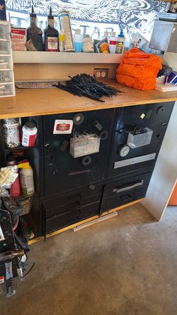 A heavy duty tool storage with casters and a three-quarter table top