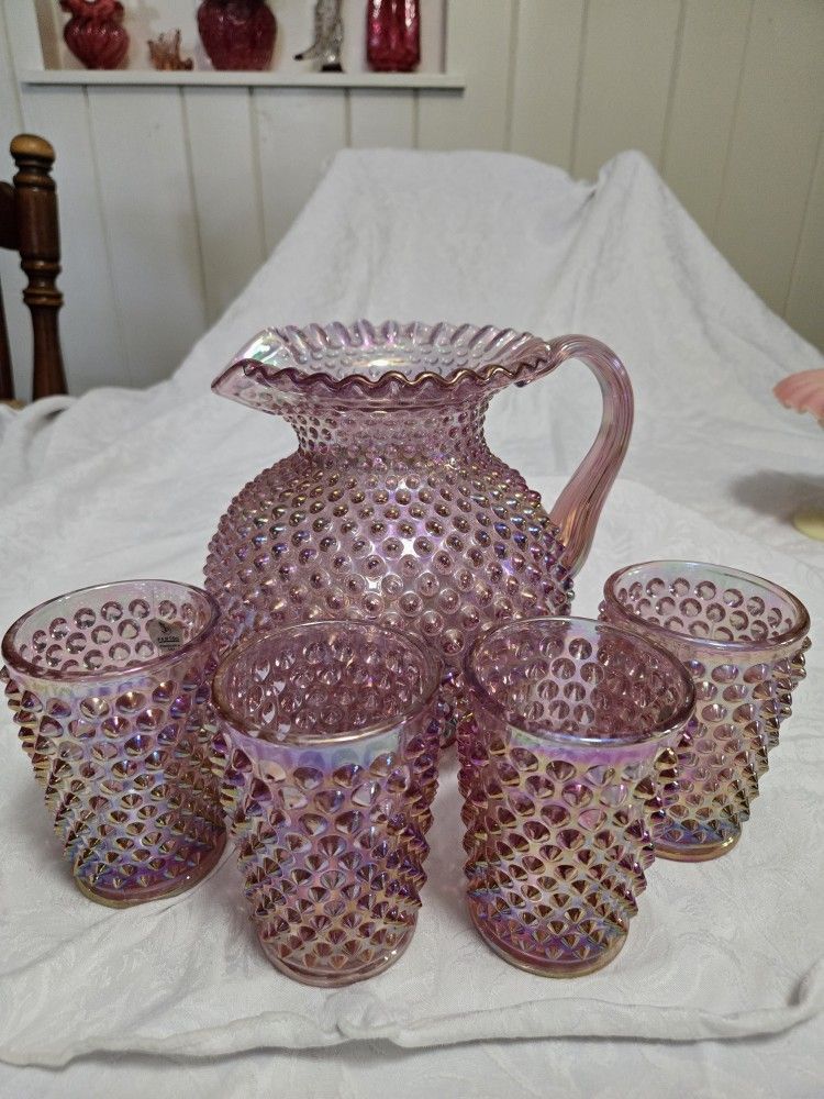 Fenton Carnival Glass hobnail pitcher with matching glasses. 