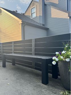 2 long black wooden benches