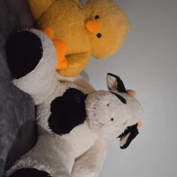 Cow stuffed animals and giant chick 