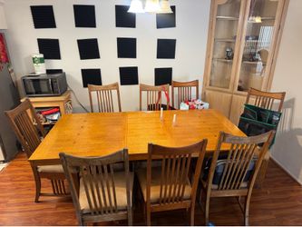 8 seater wooden table with chairs and leaf.