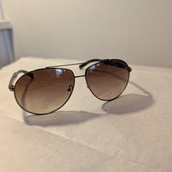 Prada SPR 50N aviator sunglasses with a gunmetal frame and brown gradient lenses. 